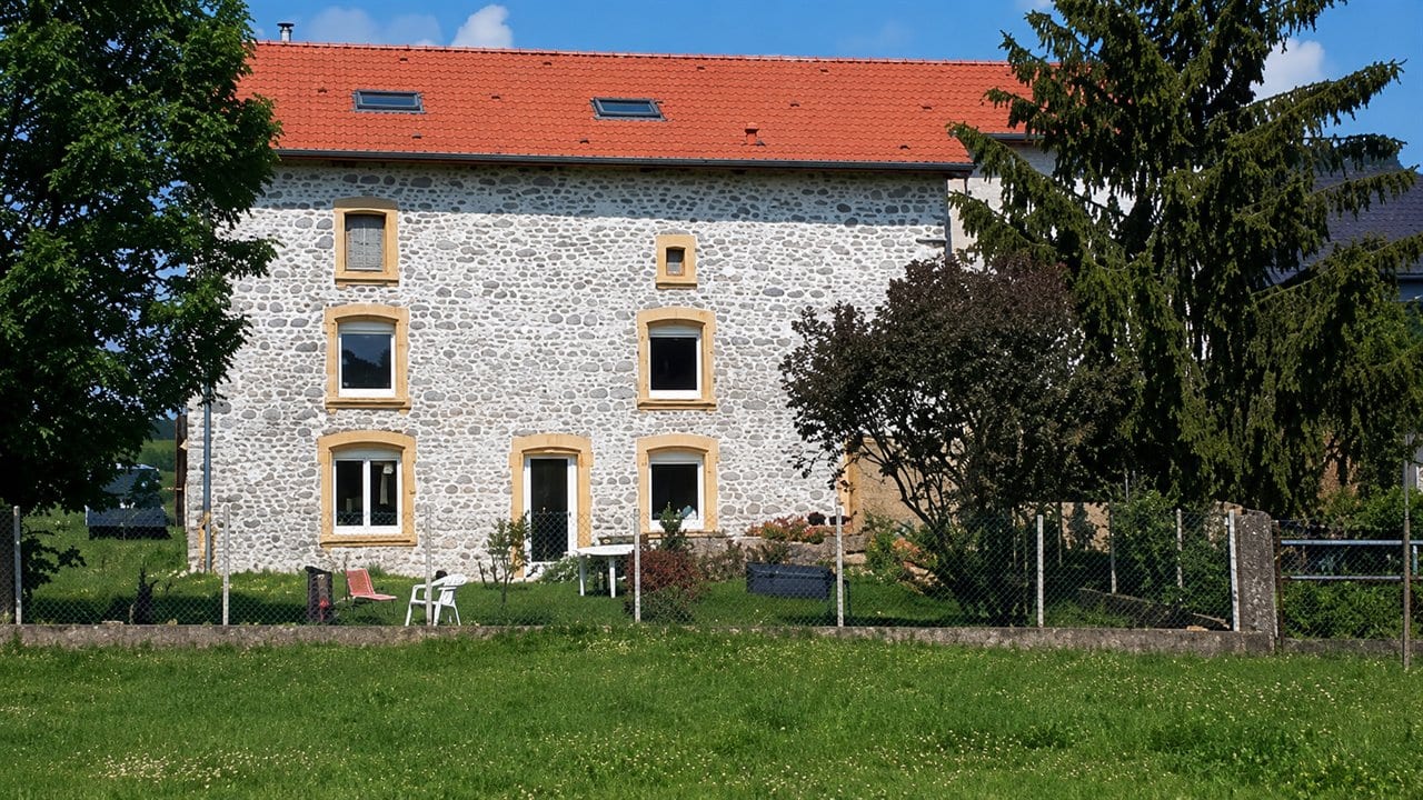 Façade en pierre rénovée par BATI-R, encadrements et toiture refaits